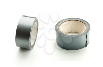 Two rolls of silver adhesive tape on white background