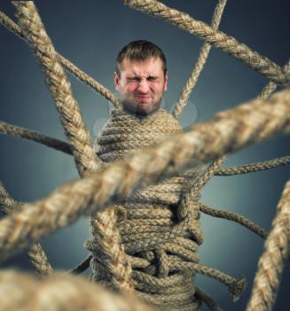 Businessman trapped in rope web