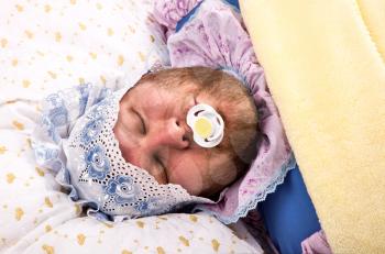 Man weared as baby sleeping with pacifier