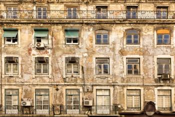 Old faded european house with wooden windows, Portugal
