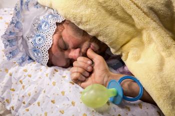Man weared as baby sleep sucking his thumb