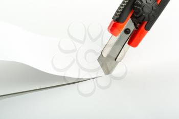 Macro of office knife cutting paper