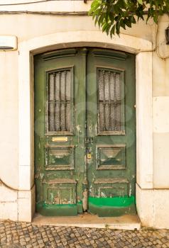 Old green entrance door close up