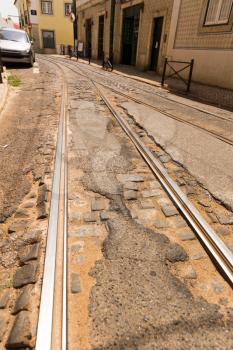 Tram-lines on paved road on the narrow street