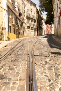 Tram rails on paved road on the narrow street closeup
