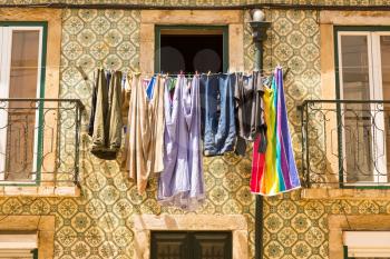 Colorful clothing is drying at the window