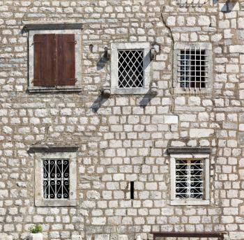 Background of old windows in a stone wall