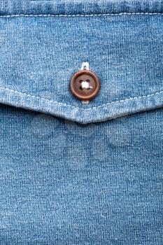 A closeup of jeans pocket with plastic button