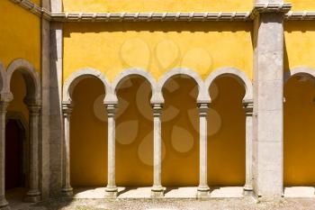 Yellow castle wall with arches