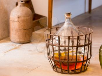 Carboy with some beverage stands on the floor in the kitchen
