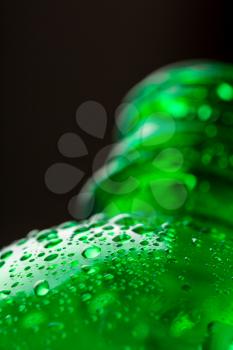 Drops on green water bottle closeup