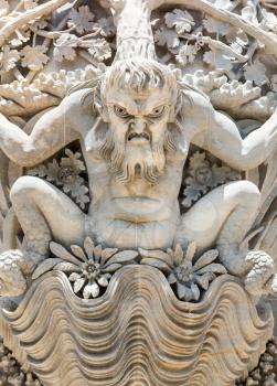 Stucco statue of male monster closeup