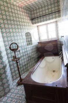 Old vintage bath-room interior with a vindow