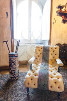 Soft vintage armchair stands in the room