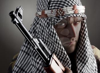 Portrait of serious middle eastern man with AK-47