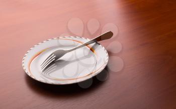 White plate and fork on the table