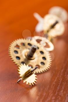 Different gears on the wooden table in a row