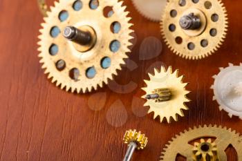 Old different gears on the wooden table