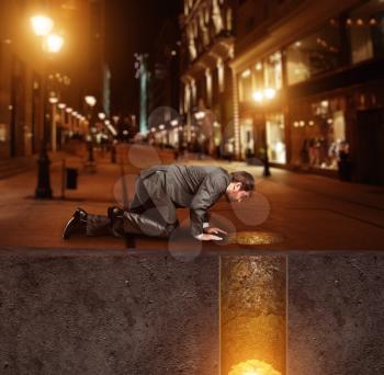 Businessman on knees on the street found treasure underground