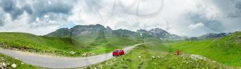 Panorama of mountains of Montenegro with car and traveler on the bench