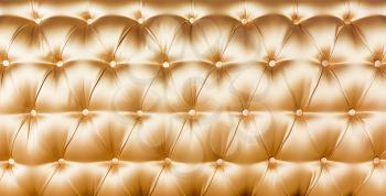 Buttoned yellow texture. Luxurious background.