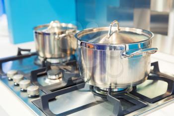 Stove with two saucepans on the modern kitchen