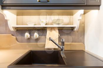 Modern kitchen sink in black ceramic closeup
