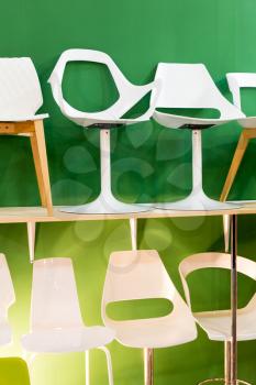 Bar chairs at a modern green backround, closeup