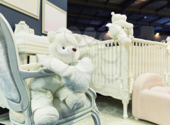 Baby bedroom with white teddy bear on the chair