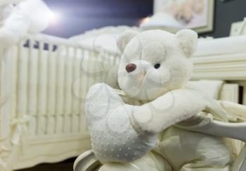 Baby bedroom with white teddy bear closeup