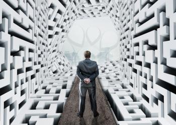 Businessman standing in abstract labyrinth
