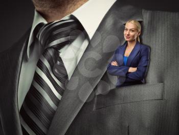 Small blond businesswoman in gray male suit pocket