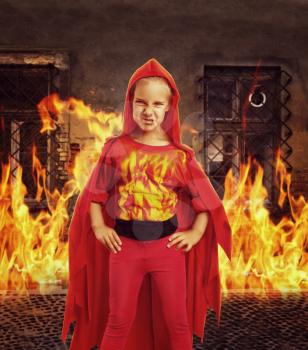 Angry girl in superhero costume in burning room