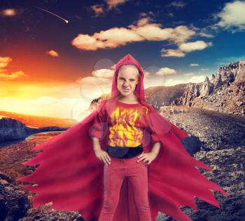 Angry girl in superhero costume in mountains
