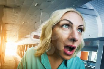 Blonde deeply surprised woman in the office