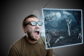 Scared man in 3D glasses looking at terrible picture