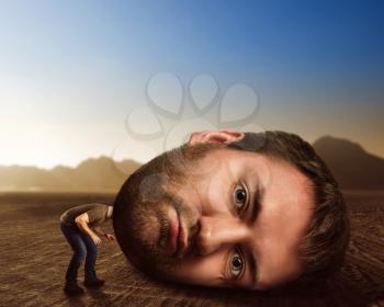 Man with enormous head in the desert