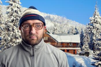 Bearded retro man in glasses in winter mountains 
