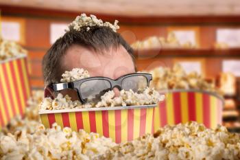 Man in glasses in a bucket of popcorn