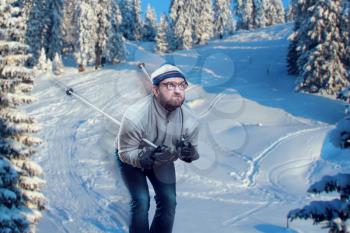 Vintage skier in glasses skiing fast while snowing