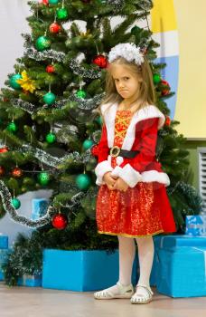 Offended girl at Christmas tree