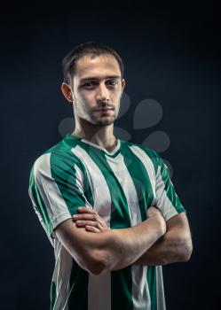 Portrait of confident Football player with crossed arms