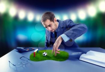 Businessman is playing football with fingers on the desk