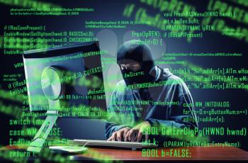 Hacker in mask stealing information in the office
