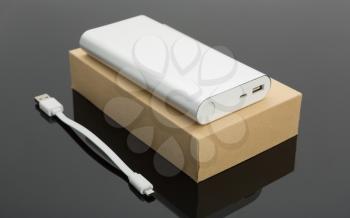 Power bank on the box and a short cable on the table
