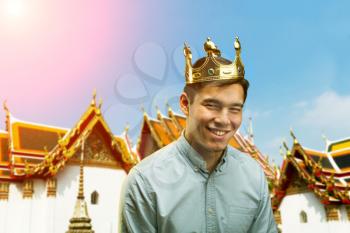Portrait of a happy prince against asian temple