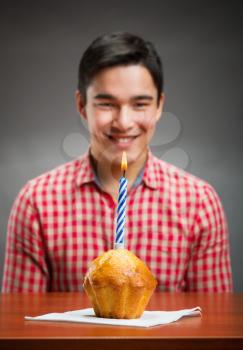 Happy birthday boy and a cupcake with candle