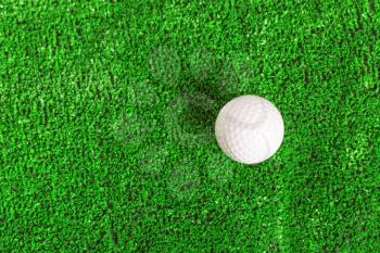 Up view of golf ball on the green lawn