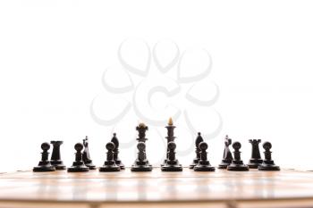 Black chess figures on the board isolated