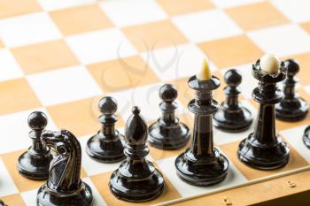 Black chess figures on the board ready to fight